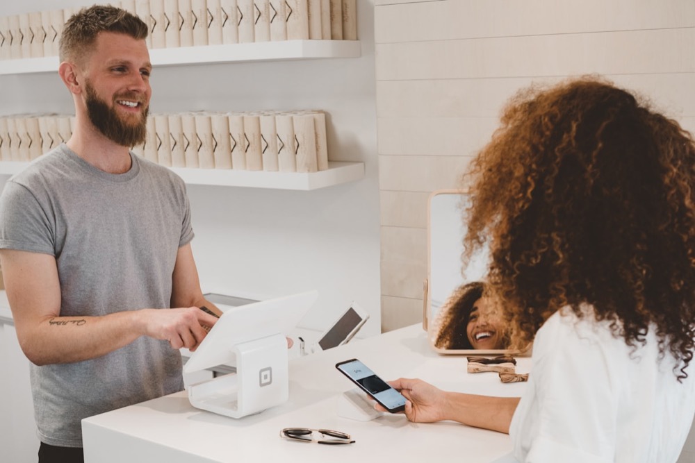 Shop owner taking a card payment at the counter