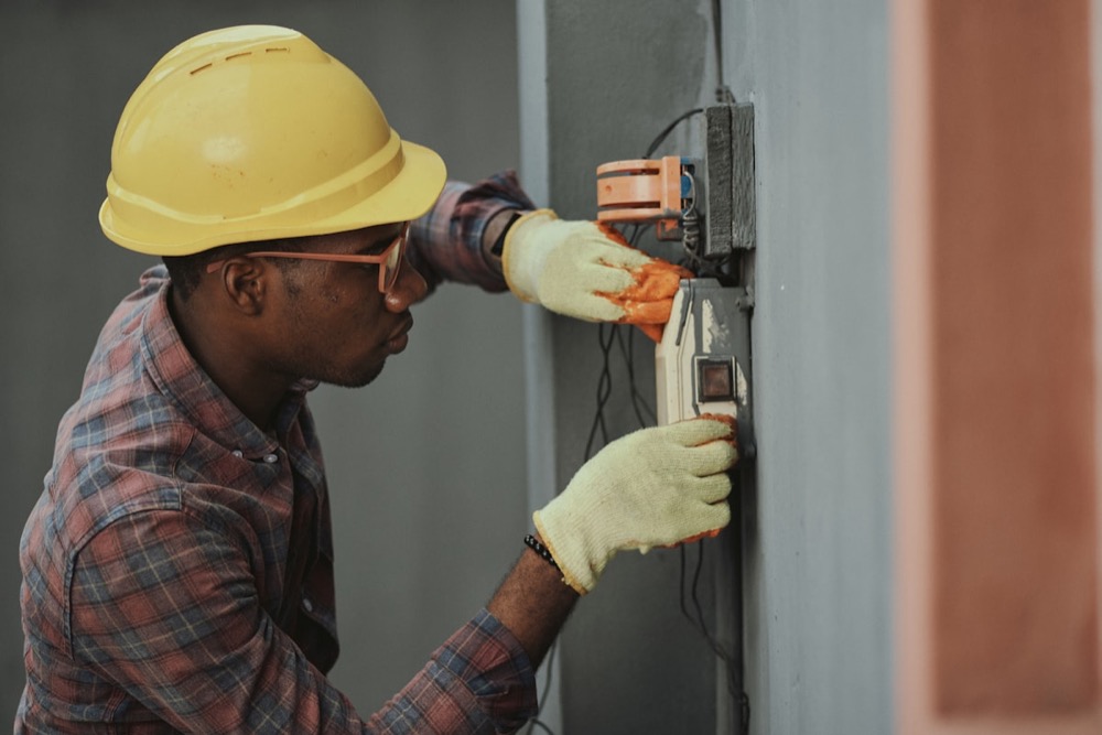 Electrician on site working on a fuse board